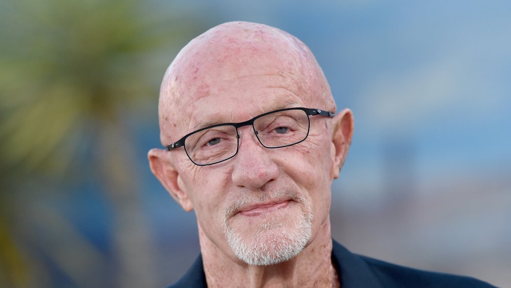 Jonathan Banks smiling, black-rimmed glasses on