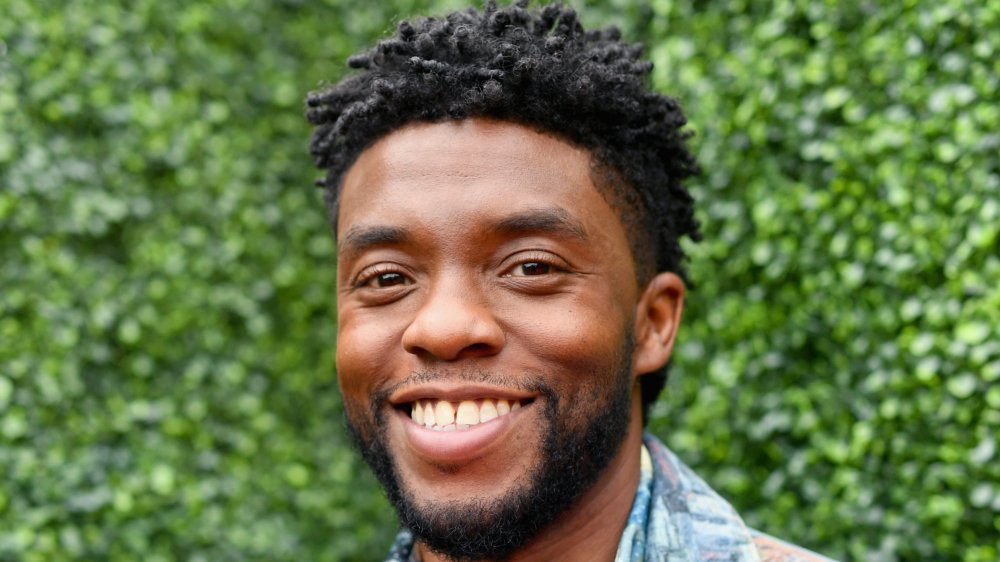 Chadwick Boseman, smiling outside 