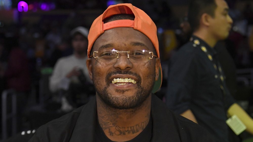 Schoolboy Q with neon orange cap, grinning