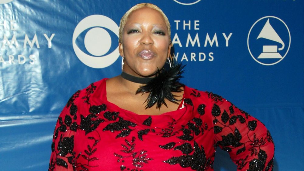 Frenchie Davis in a red-and-black top, posing at the Grammys