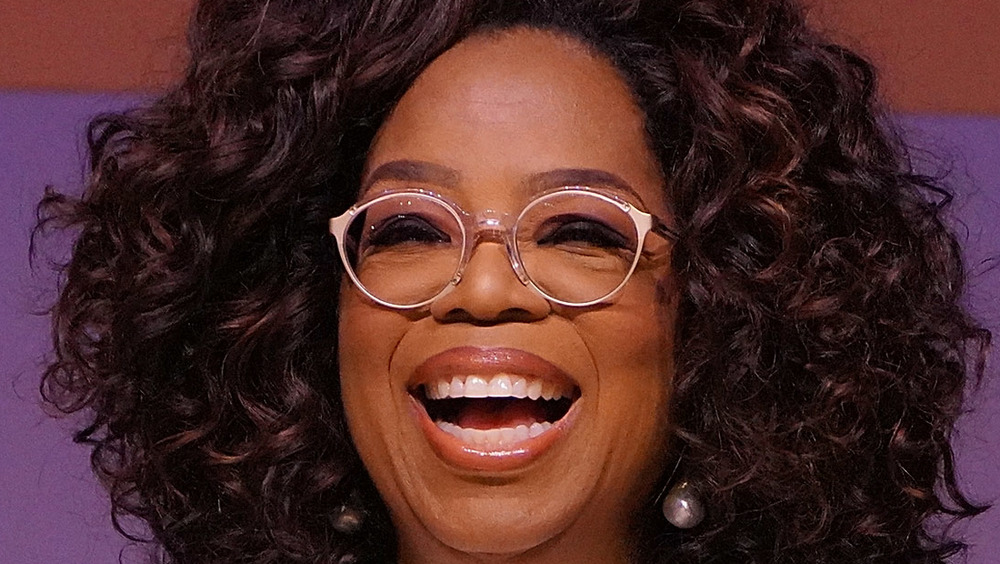 oprah sorride con grandi capelli