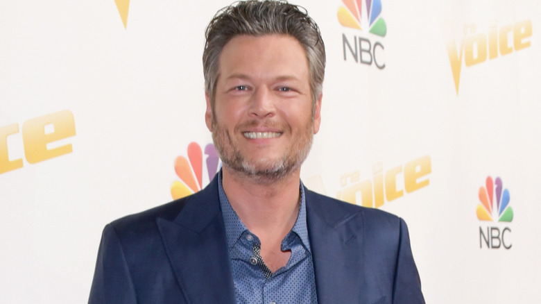 Blake Shelton sorride sul red carpet per la premiere di The Voice