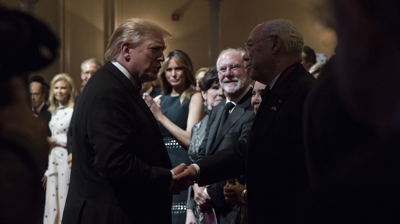 Donald Trump e Colin Powell si stringono la mano nel 2019