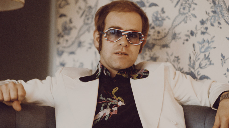 Elton John seduto su un divano