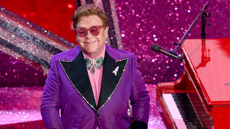 Elton John guarda il pubblico dal suo pianoforte