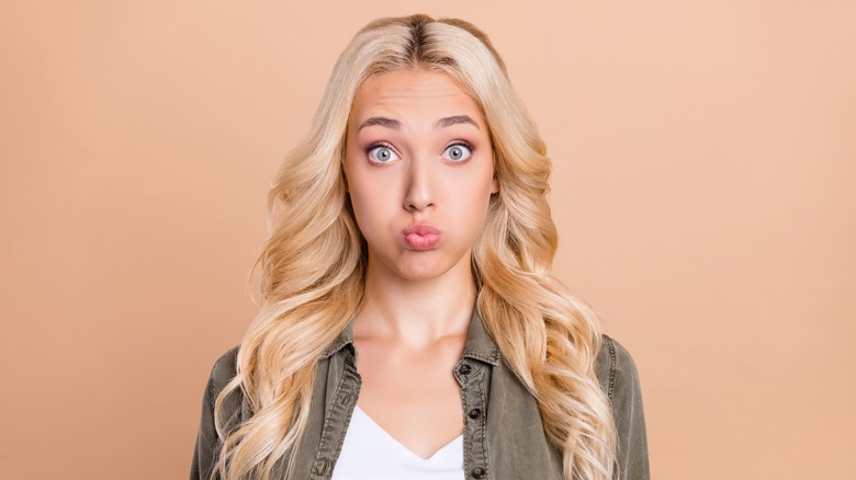 Donna con i capelli biondi che fa la faccia