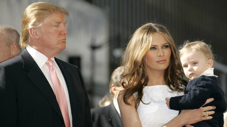 Melania Trump tiene in braccio Barron Trump accanto a Donald Trump