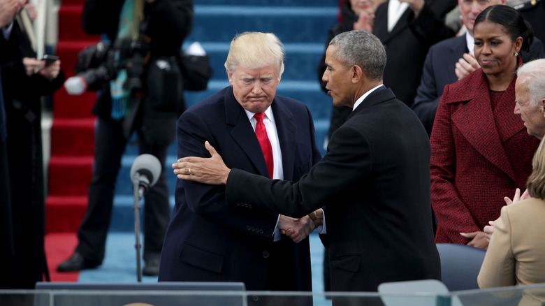 Barack Obama mette la mano sul braccio di Donald Trump