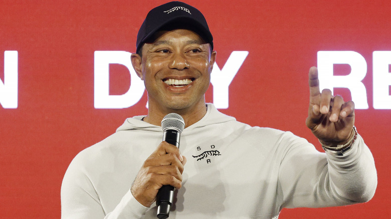 Tiger Woods tiene in mano un microfono