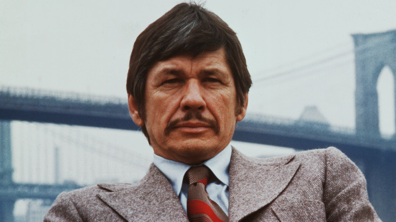 Charles Bronson seduto in abito di lana