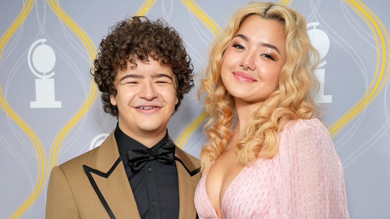 Gaten Matarazzo e Lizzy Yu sorridono