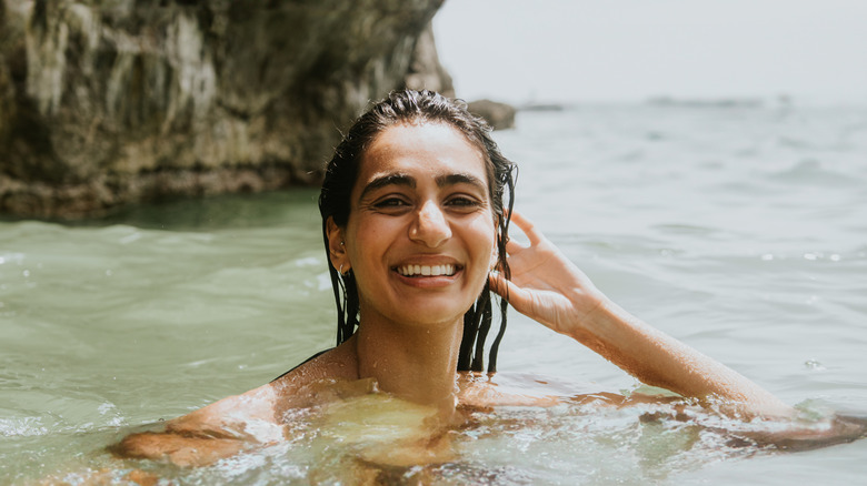 Donna sorridente nell'oceano