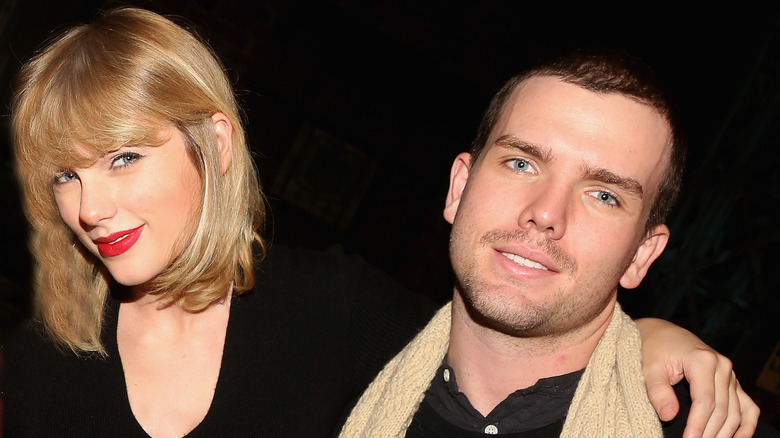 Taylor Swift sorride con il braccio attorno ad Austin Swift